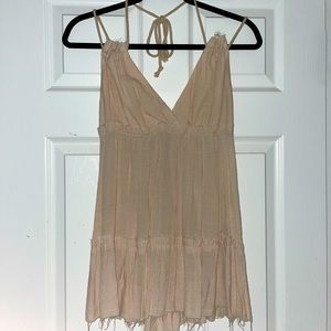 Tank blouse, cream color. Rope-like tie details with ruffles & raw hem.